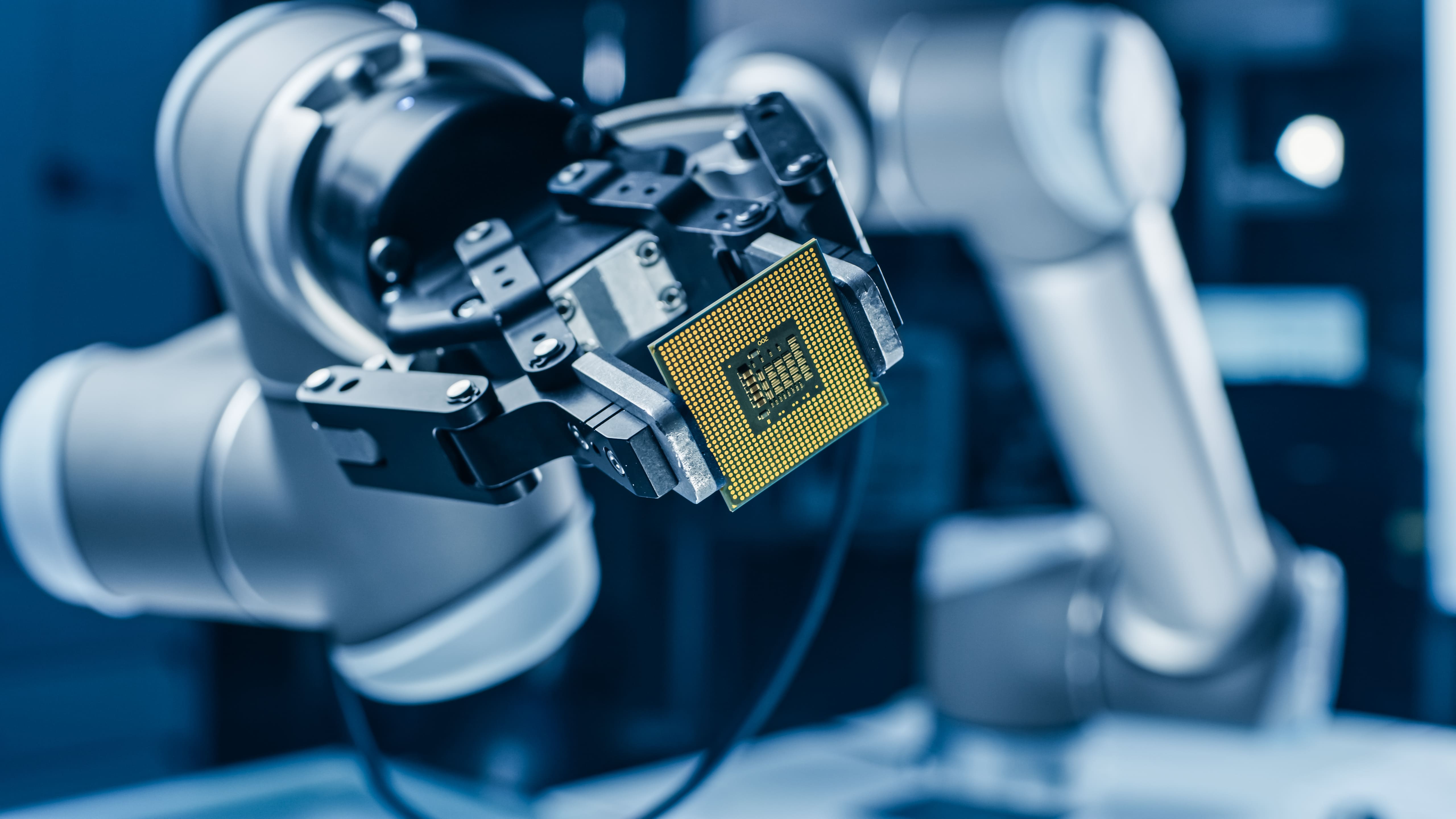 Robotic equipment handling a semiconductor component.