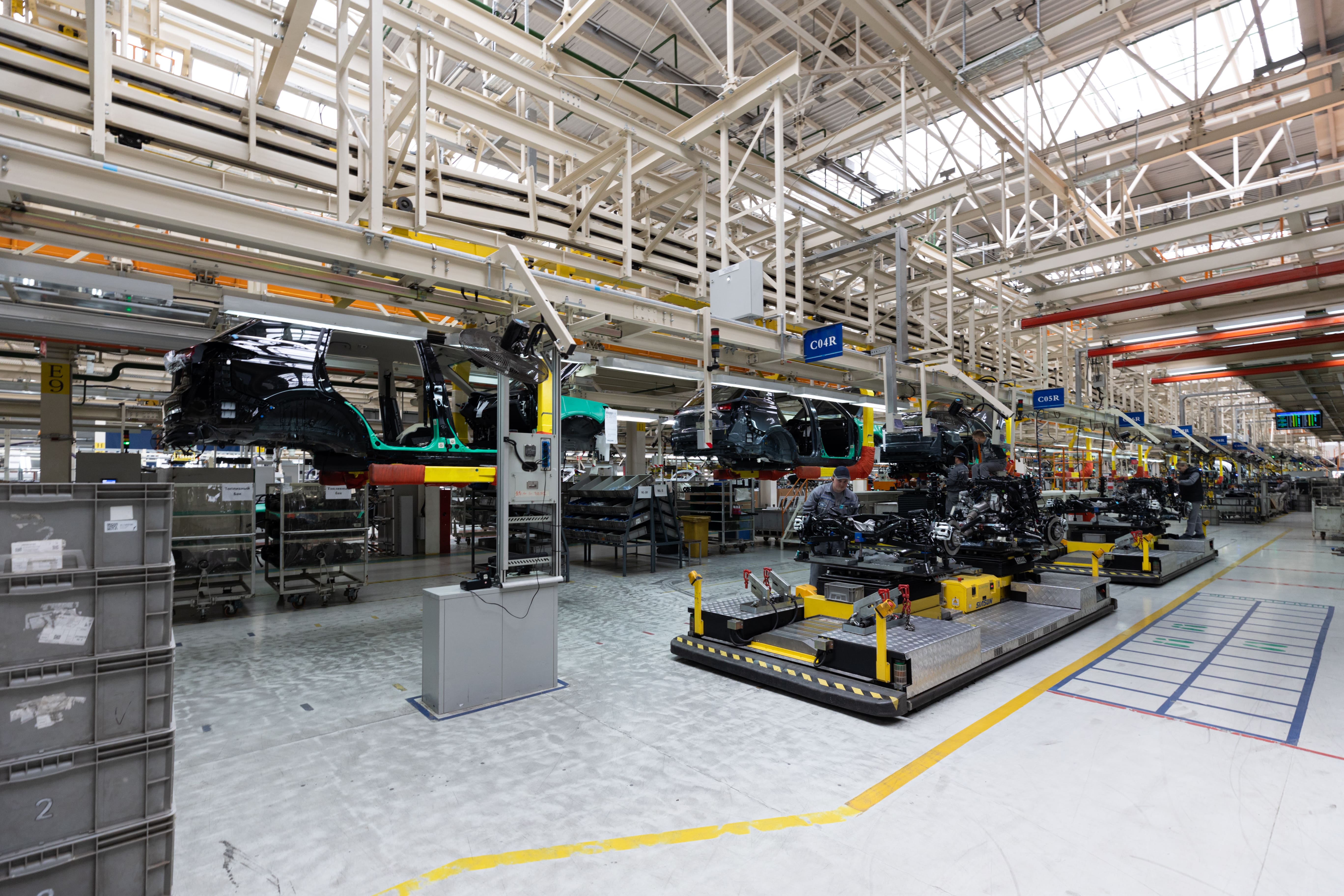 Vehicles moving through an automotive production facility.