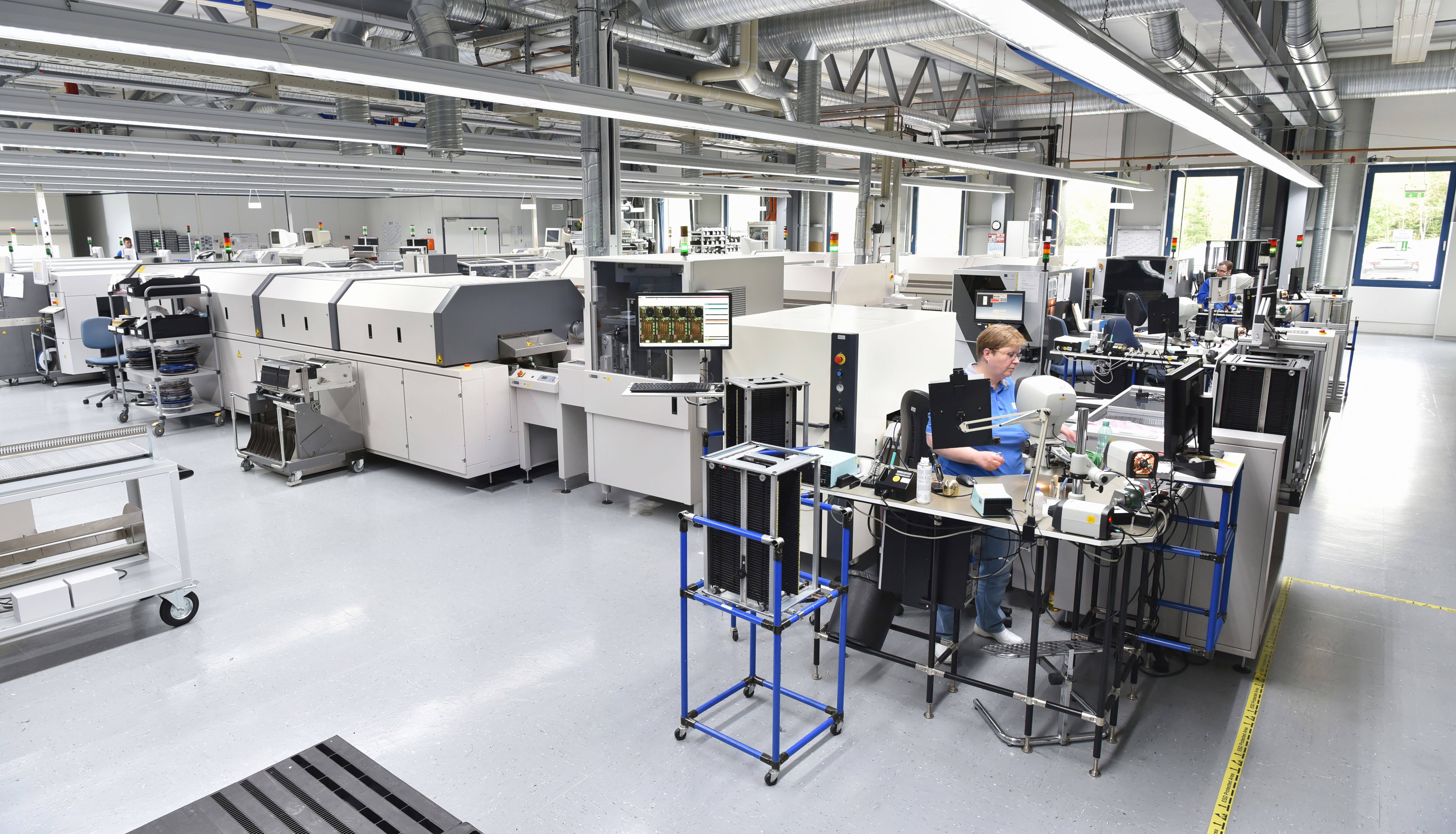 Electronics manufacturing equipment across a connected SMT production floor.