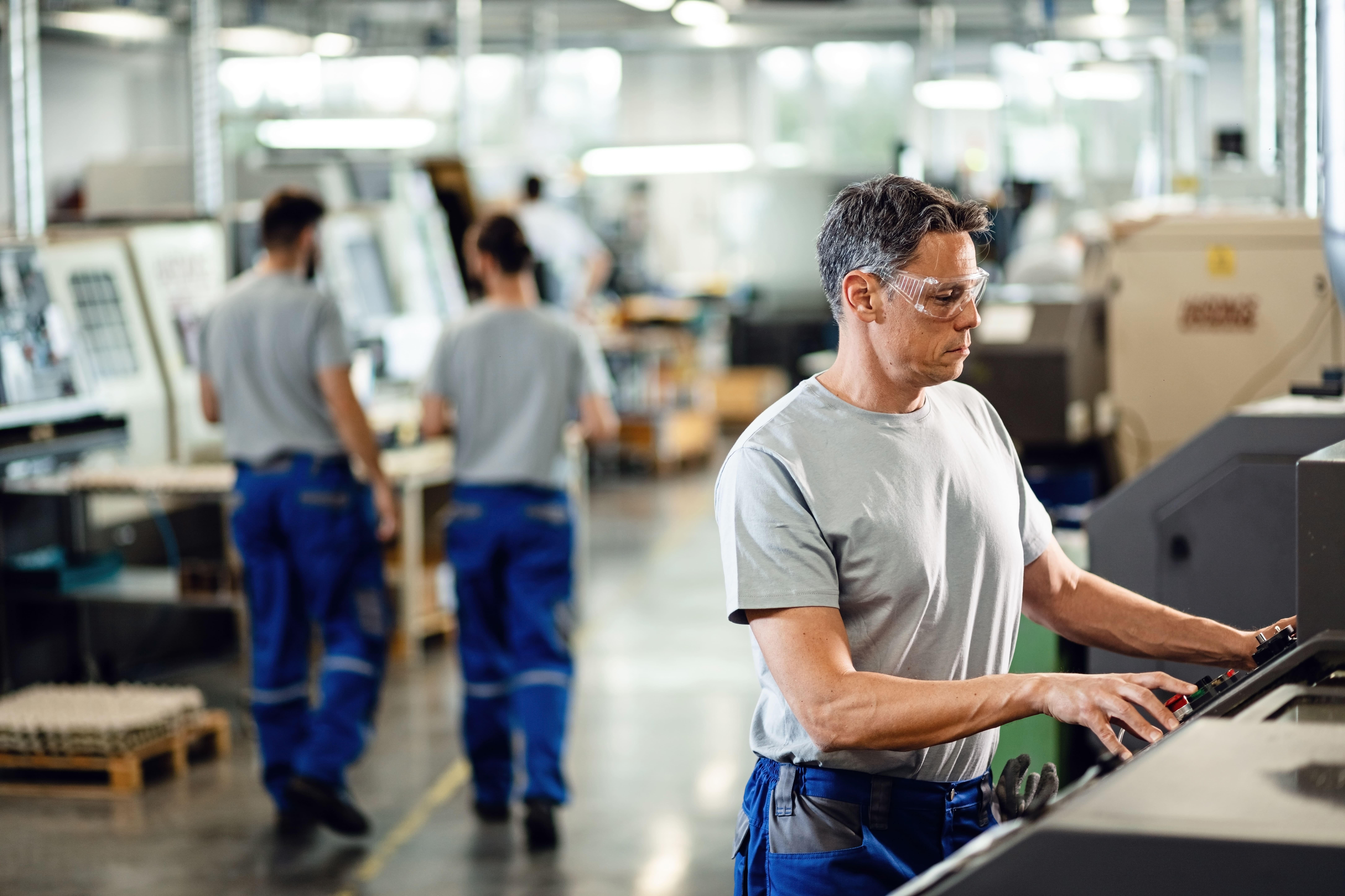 Production team working on an industrial assembly line after equipment release.
